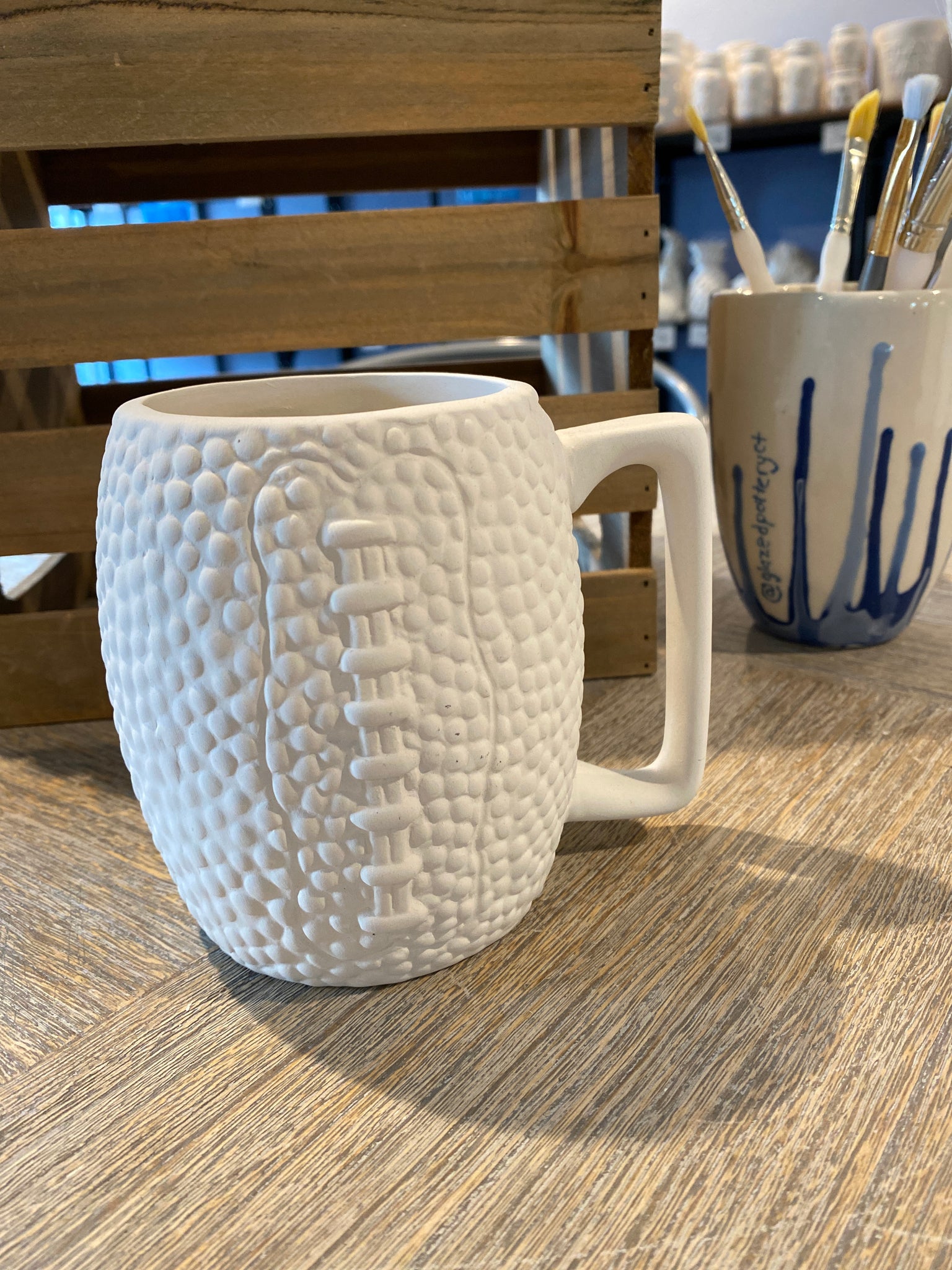 Textured Football Mug – Glazed Pottery Painting & Art Studio